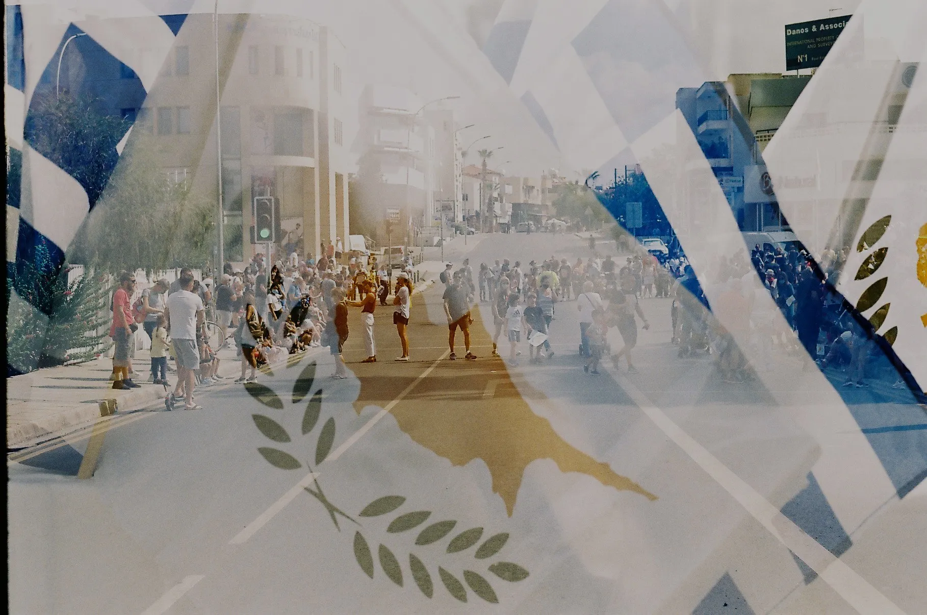 A crowd marching through a city street layered with European flags