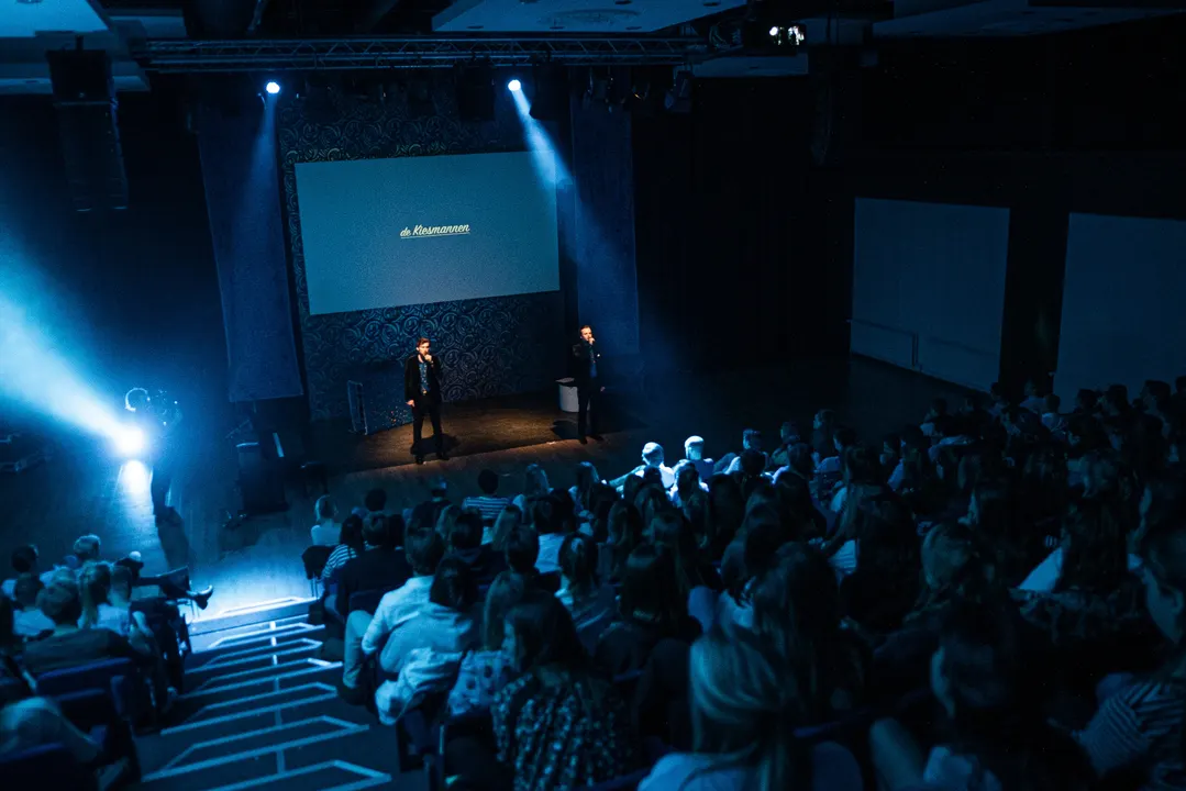 A packed, dark auditorium during a show